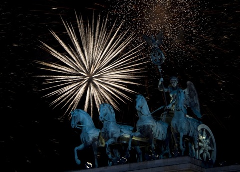 Fireworks erupt over the Brandenburg Gate on January 1, 2013 in Berlin as part of the New Year's celebrations.